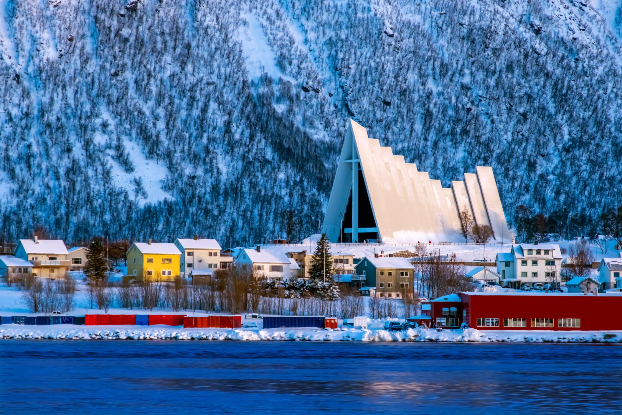 Tromsø, with its Arctic Cathedral echoing the shape of the mountains behind. Photo: Canva.