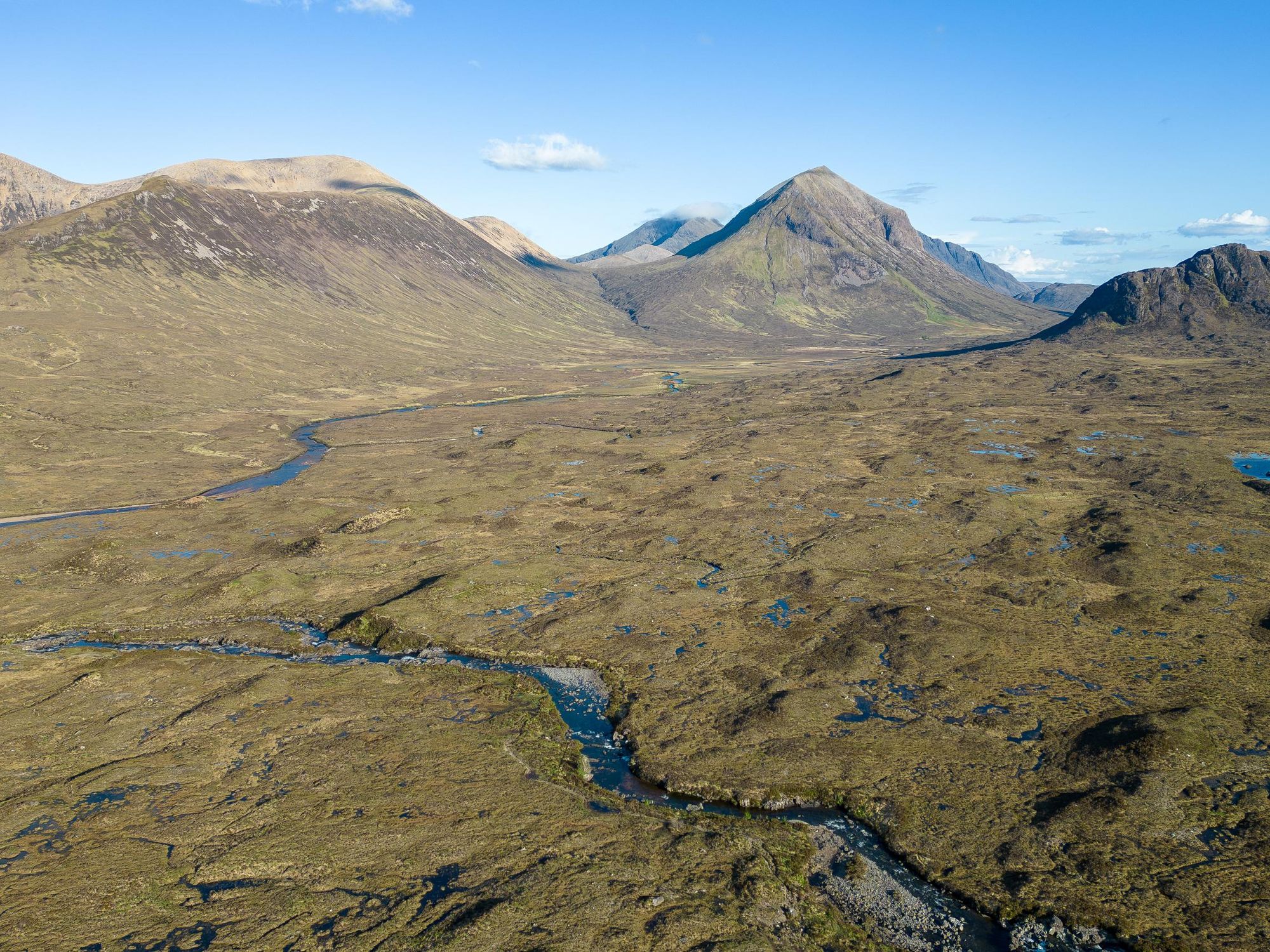 An aerial view of a typical Cuillin landscape; moorland steeply rising up to the remarkable mountain tops. Photo: Getty