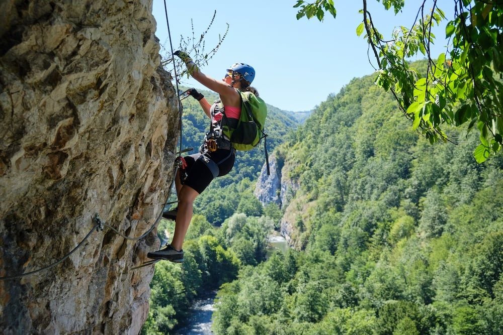 Woman on via ferrata at Suncuius, Bihor county, Romania, with Crisul Repede below her. Photo: Getty.