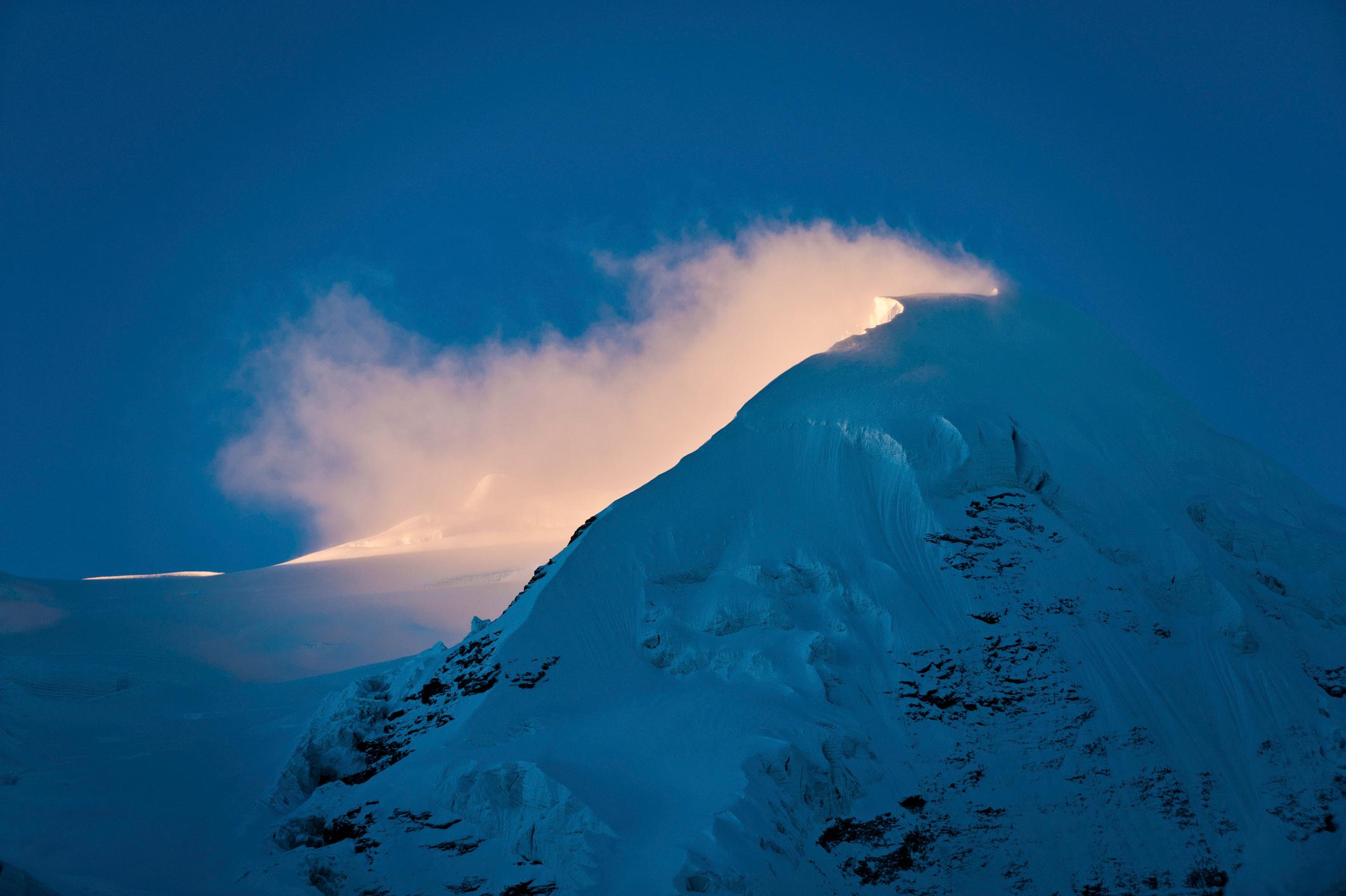 A dawn mist strikes the summit and glaciers of Mera Peak. Photo: Getty.
