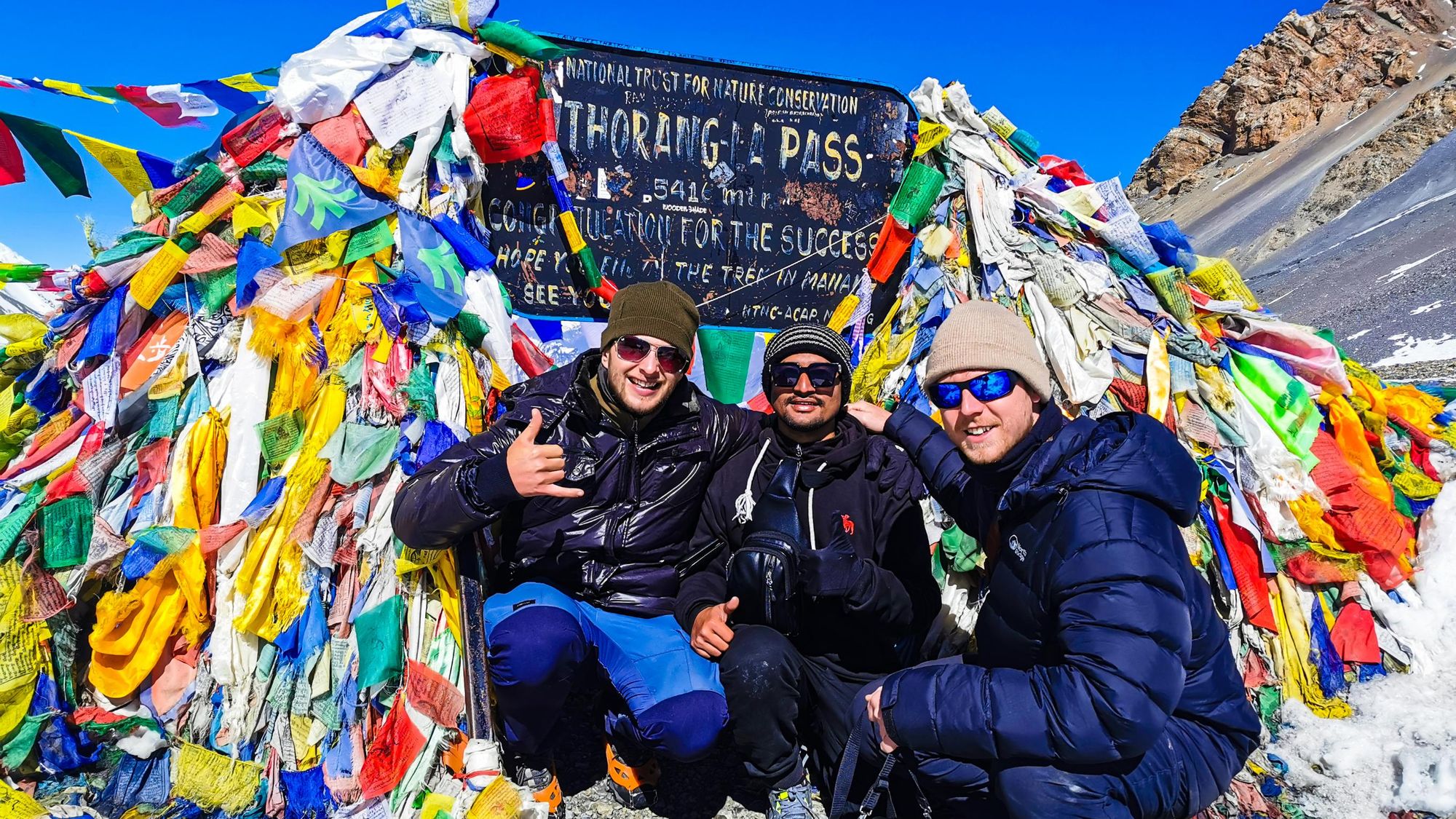 A celebratory photo at the high point of the Annapurna Circuit, at the Thorang-La Pass. Photo: Josh Edwards