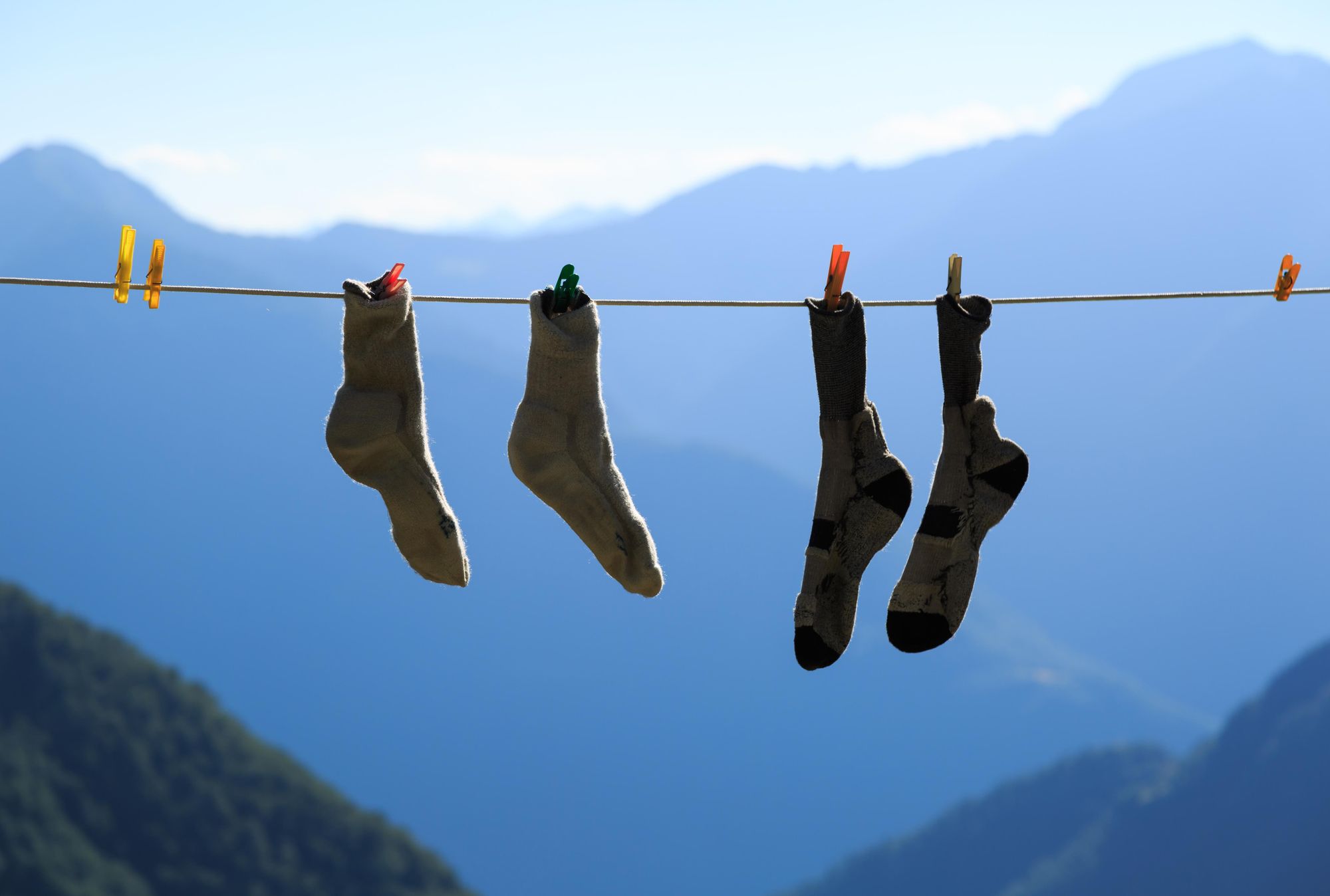Two pair of socks drying on a clothes line during an adventurous hike in the mountains. Photo: Getty