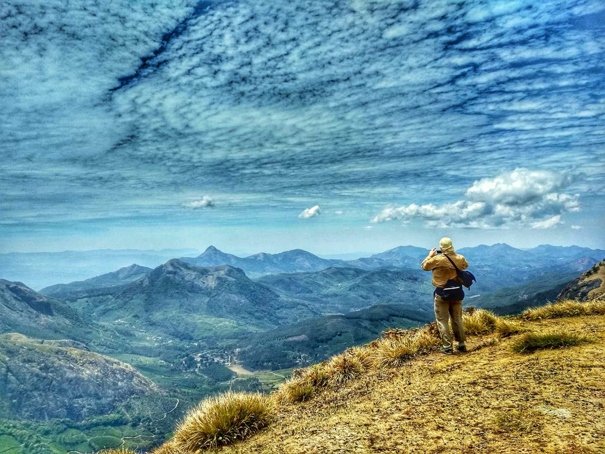 A hiker takes a photo from the top of Meesapulimala, a mountain in India. Photo: India Intrepid DMC.