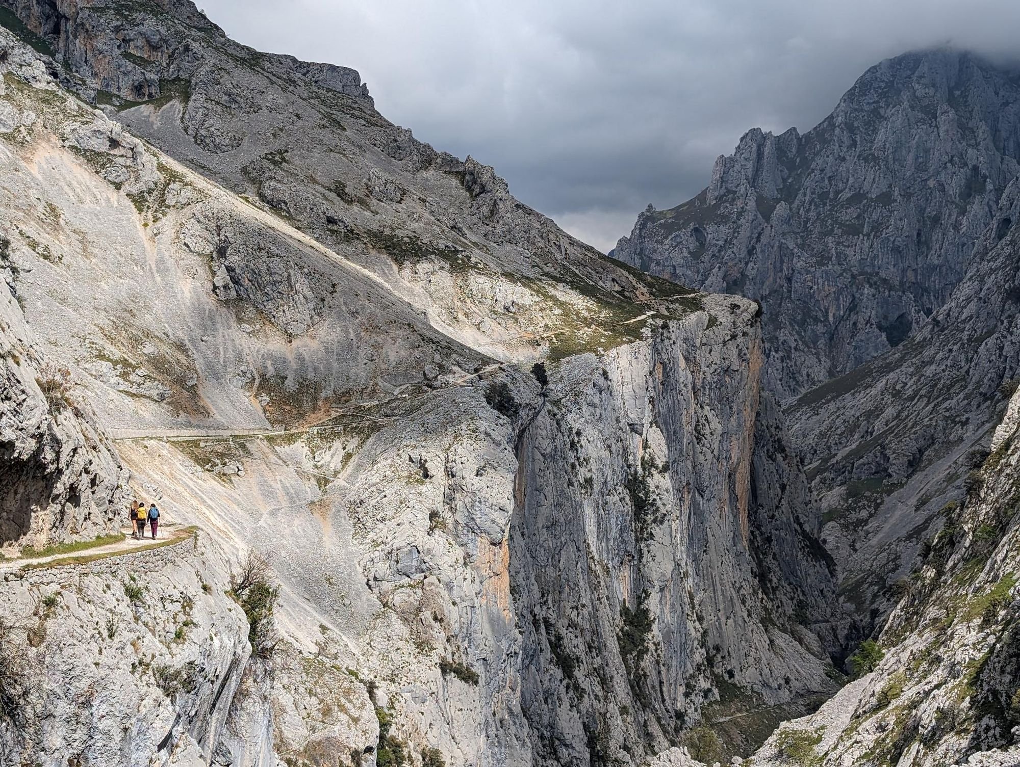 The narrow path of the Ruta del Cares curving around the gorge, as clouds draw in. Photo: Stuart Kenny