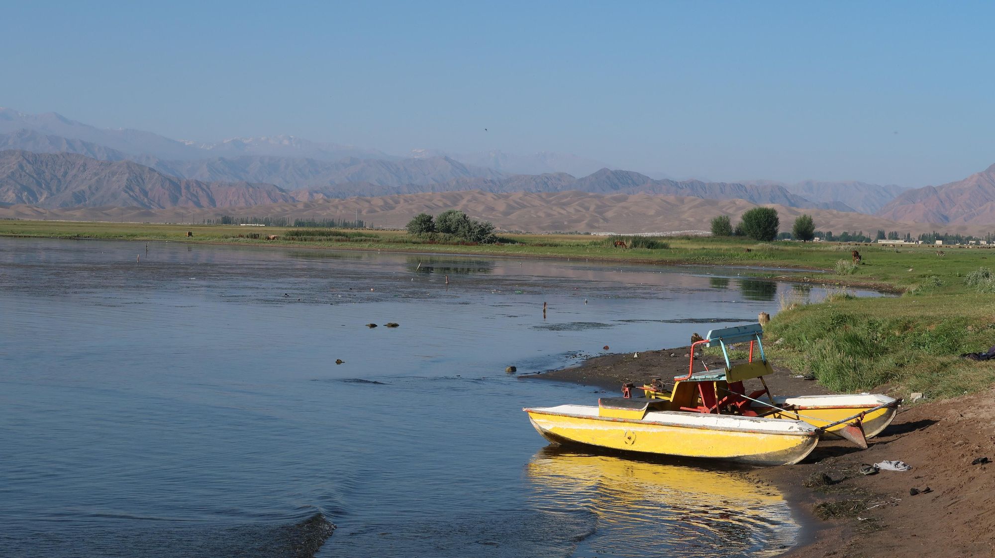 The warm waters of Issyk-Kul, with the mountains rising in the background. Photo: Markus Stitz