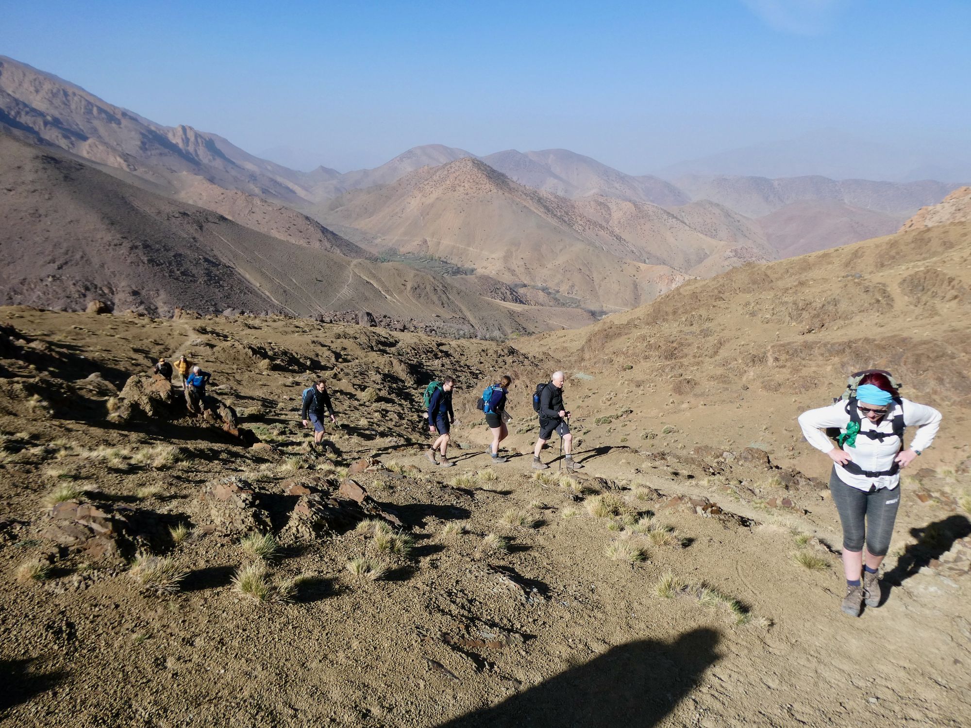 A group of hikers ascending a trail in the Atlas Mountains.
