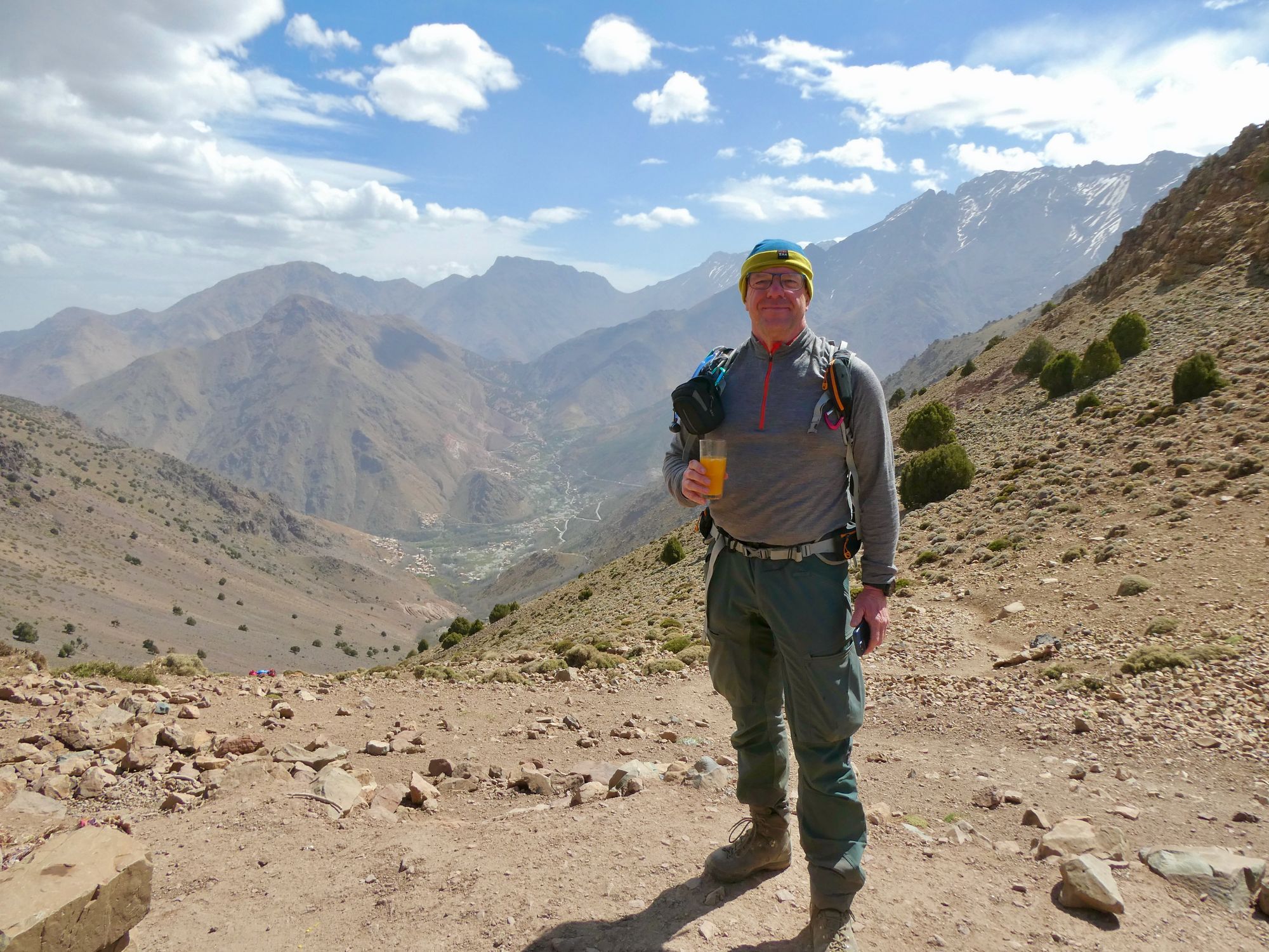 A man with a glass of orange juice in the Atlas Mountains of Morocco.