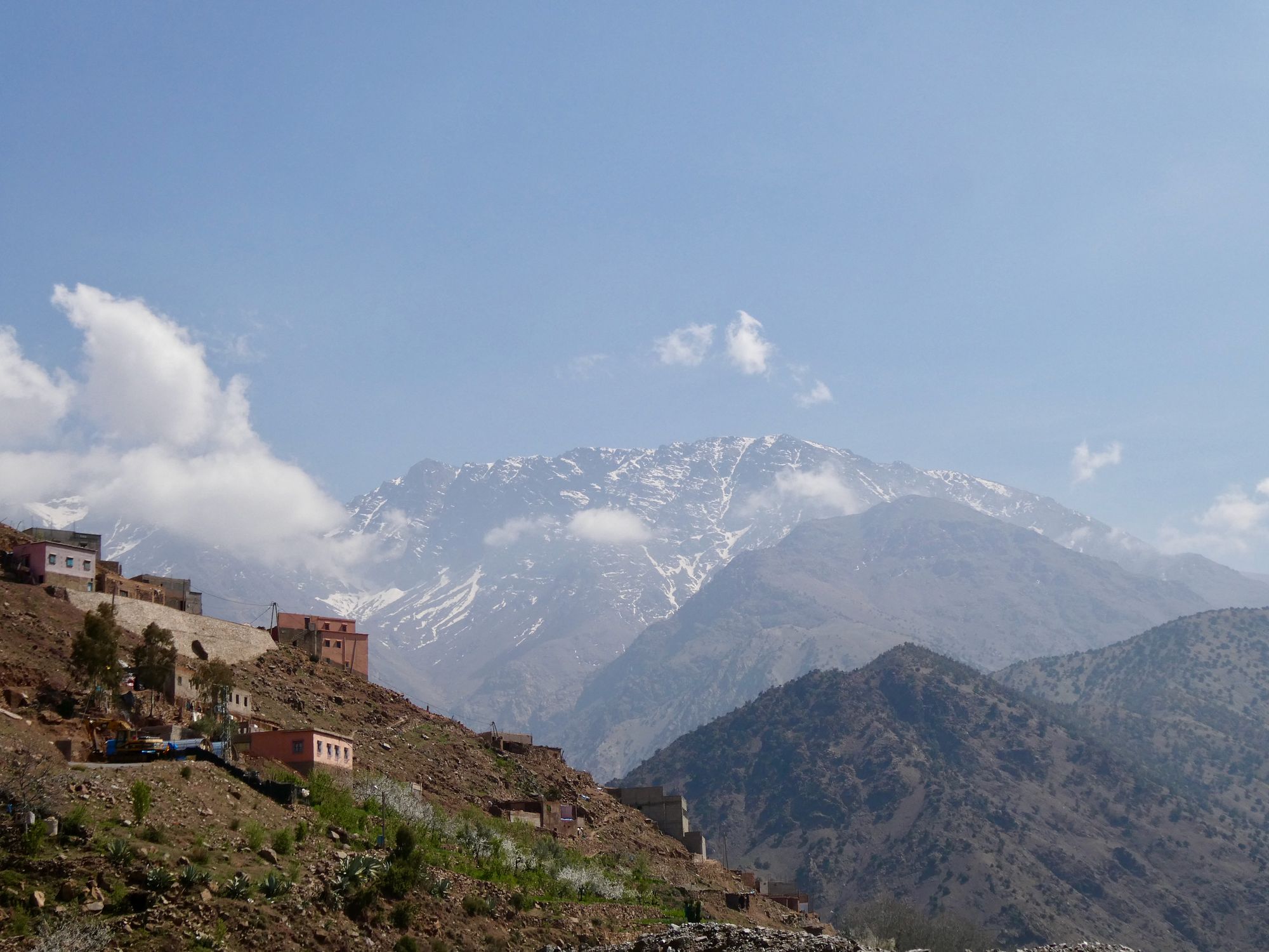A view of the Atlas Mountains, with a village in the foreground.