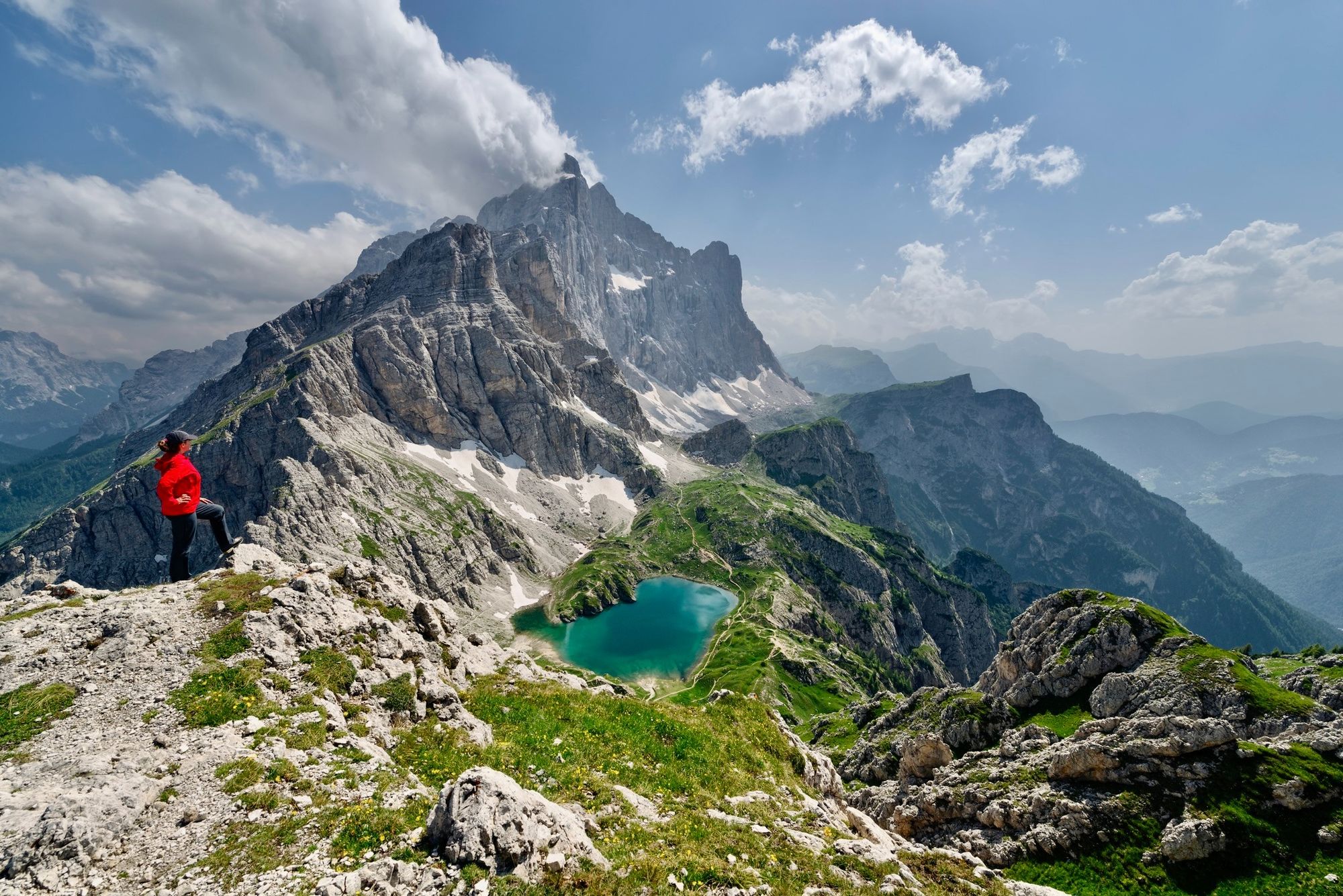 A hiker overlooking Coldai Lake in the Dolomites. Photo: Getty.