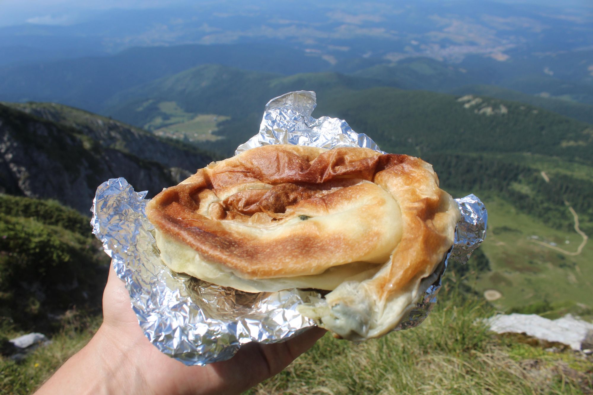 A burek filled with spinach and ready for consumption, looking out to Montenegro. Photo: Stuart Kenny