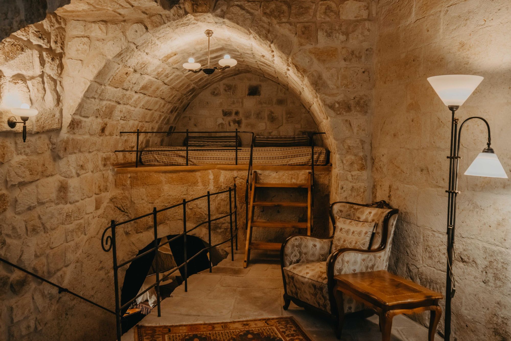 A bed, nestled in the back of a sculpted cave in Cappadocia. Photo: Dere Suites