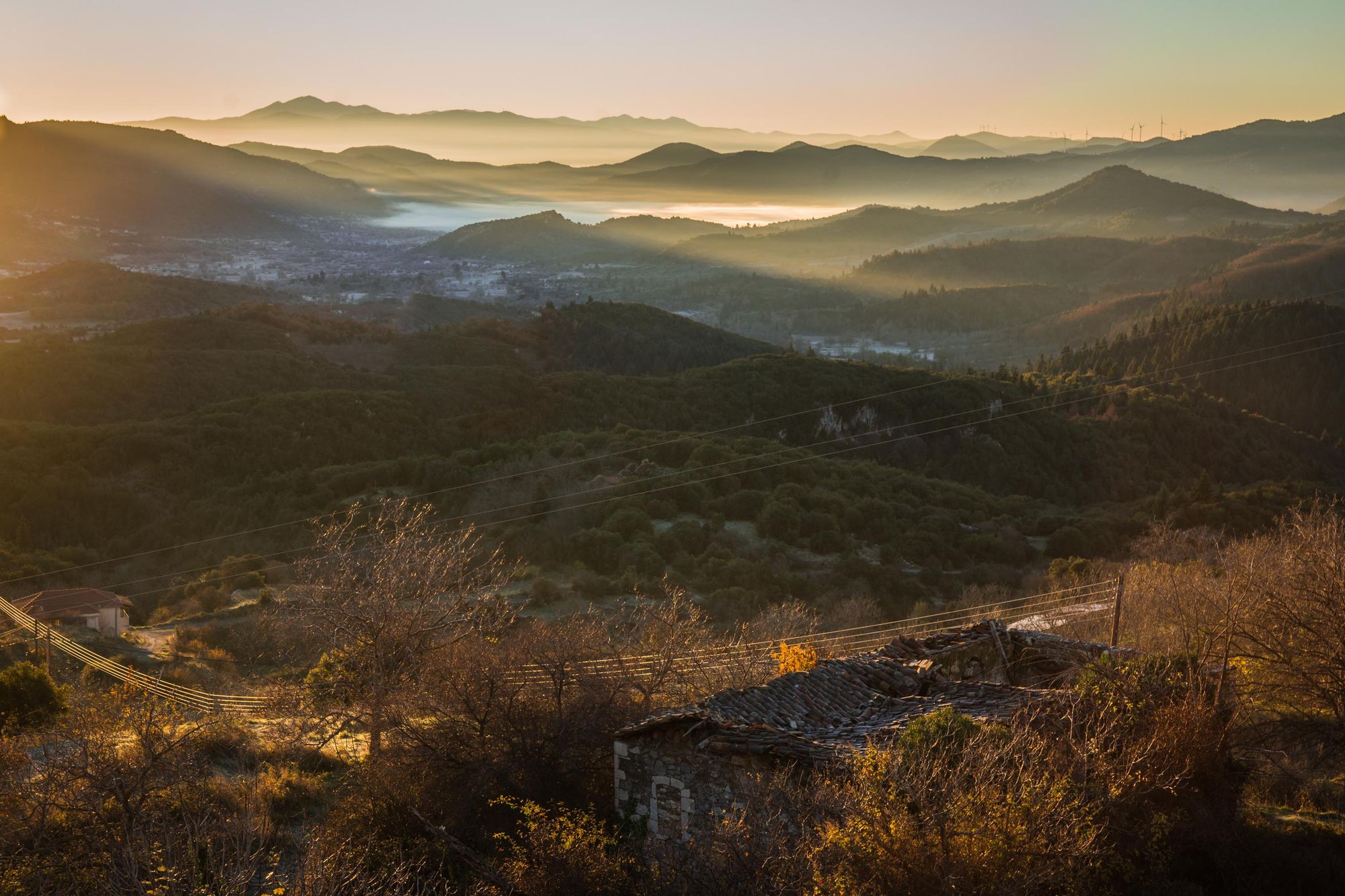 A foggy landscape of rolling green at sunset in mountains of Greece, Peloponnesem near Vytina. Photo: Getty