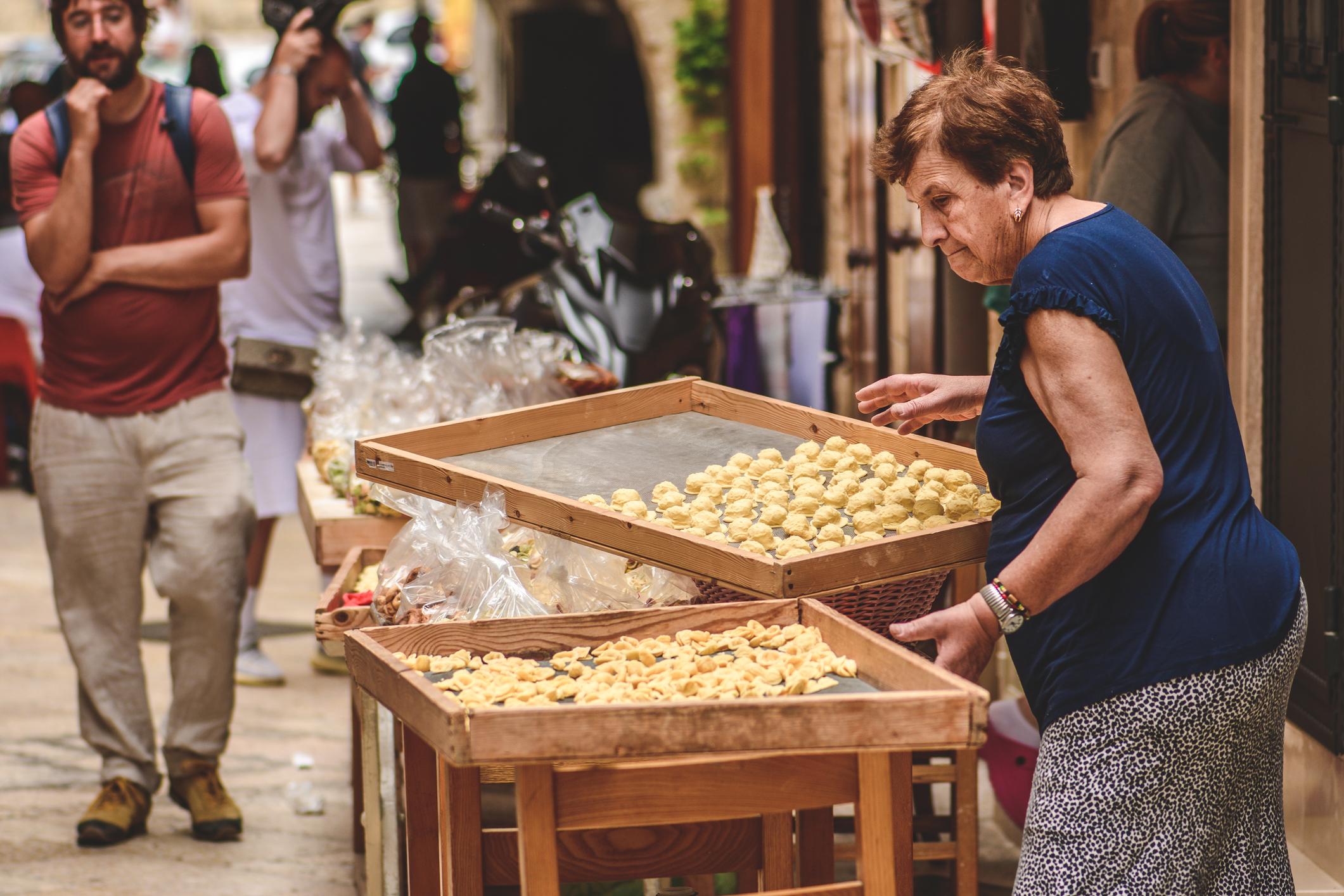 A local woman selling fresh orecchiette on the streets. Photo: Getty