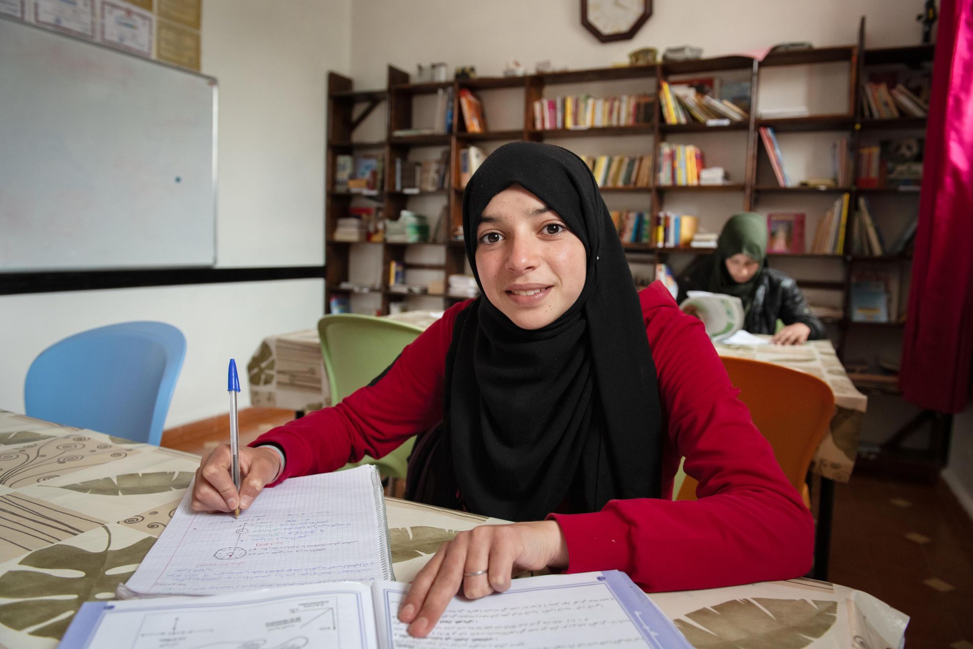 A young Moroccan girl working at her school books. Photo: Education for All.