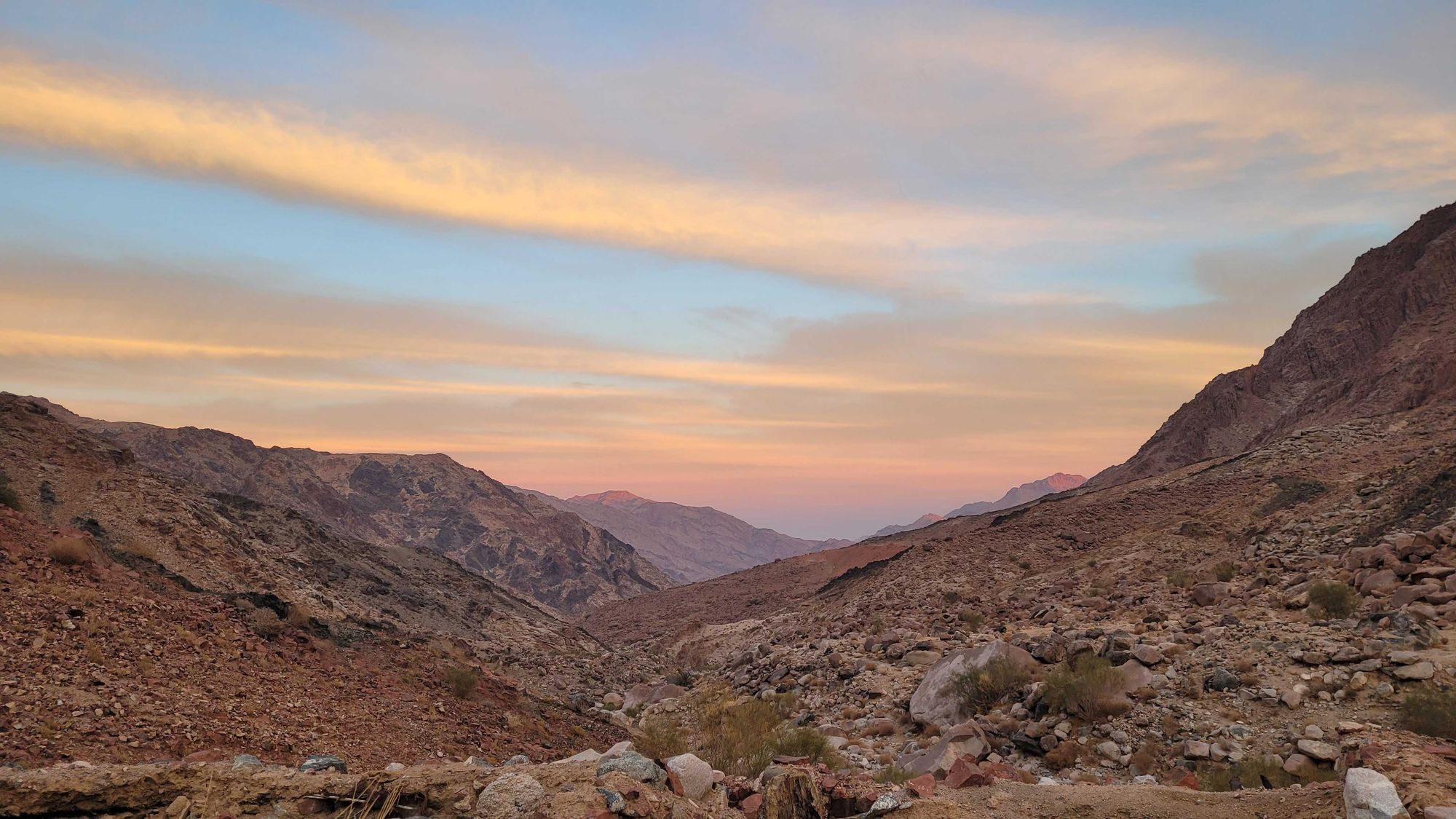 Sunrise colours in the sky overlooking a valley in the Sinai Desert.