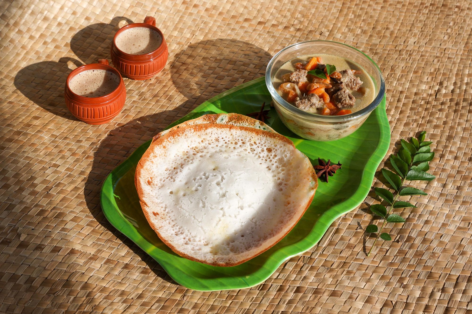 Appams and mutton stew, a traditional Keralan Syrian Christian dish. Photo: Getty.