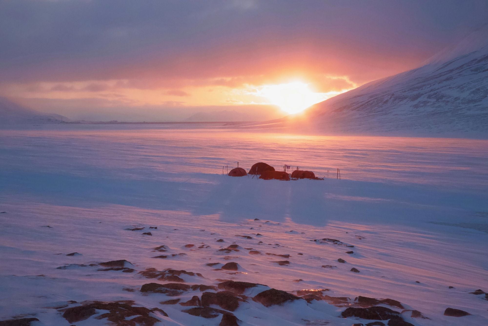The suns sets on a campsite in Svalbard. Photo: Getty.