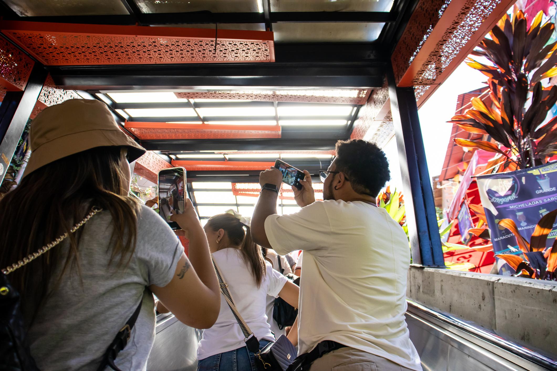 Tourists on the famous electric escalators of Comuna 13. Photo: Getty