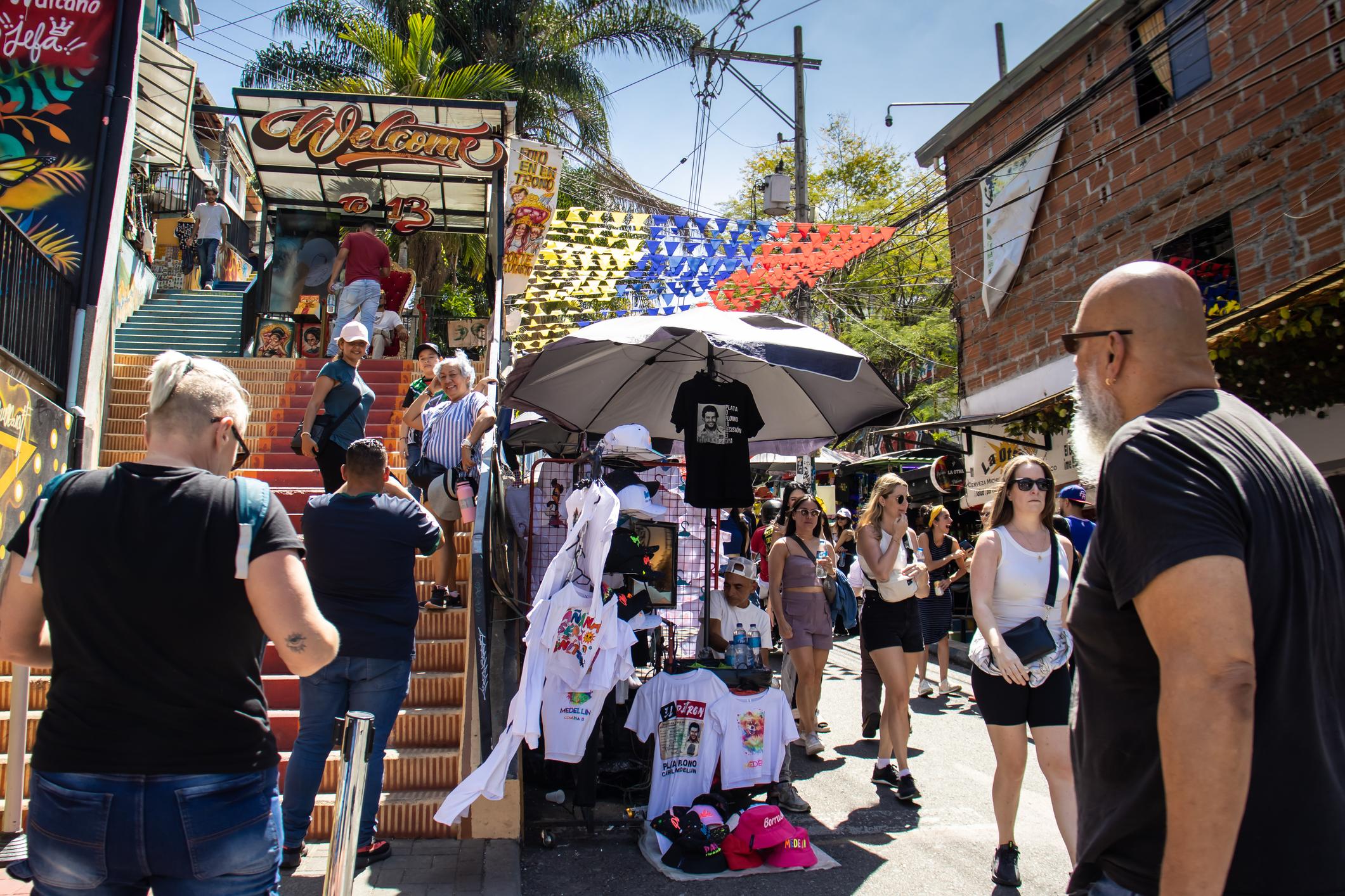 Markets sell Pablo Escobar merchandise at the entrance to Comuna 13 in Medellín. Photo: Getty