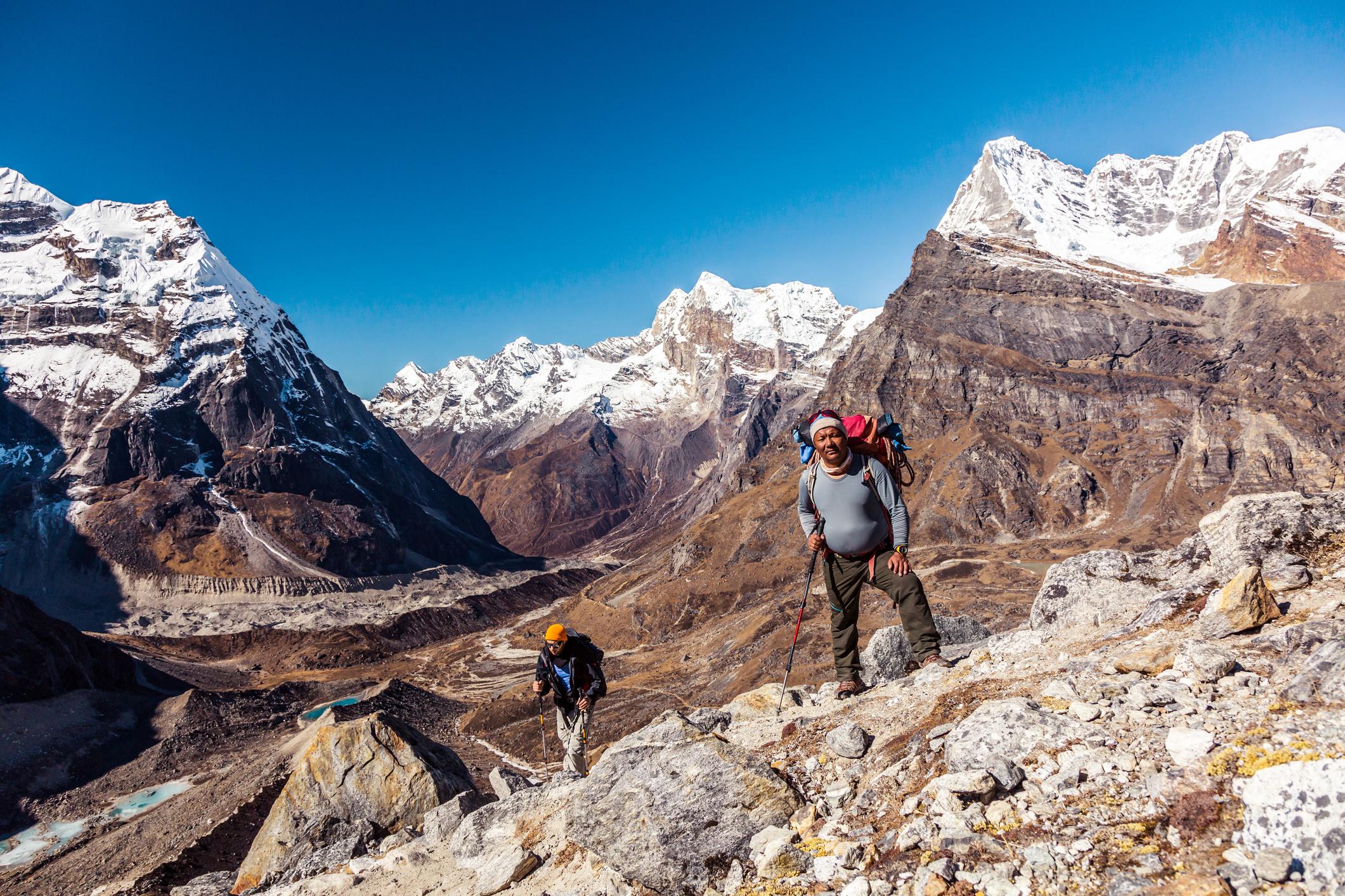 A guide leads a hiker into the mighty mountains of Nepal. Photo: Getty