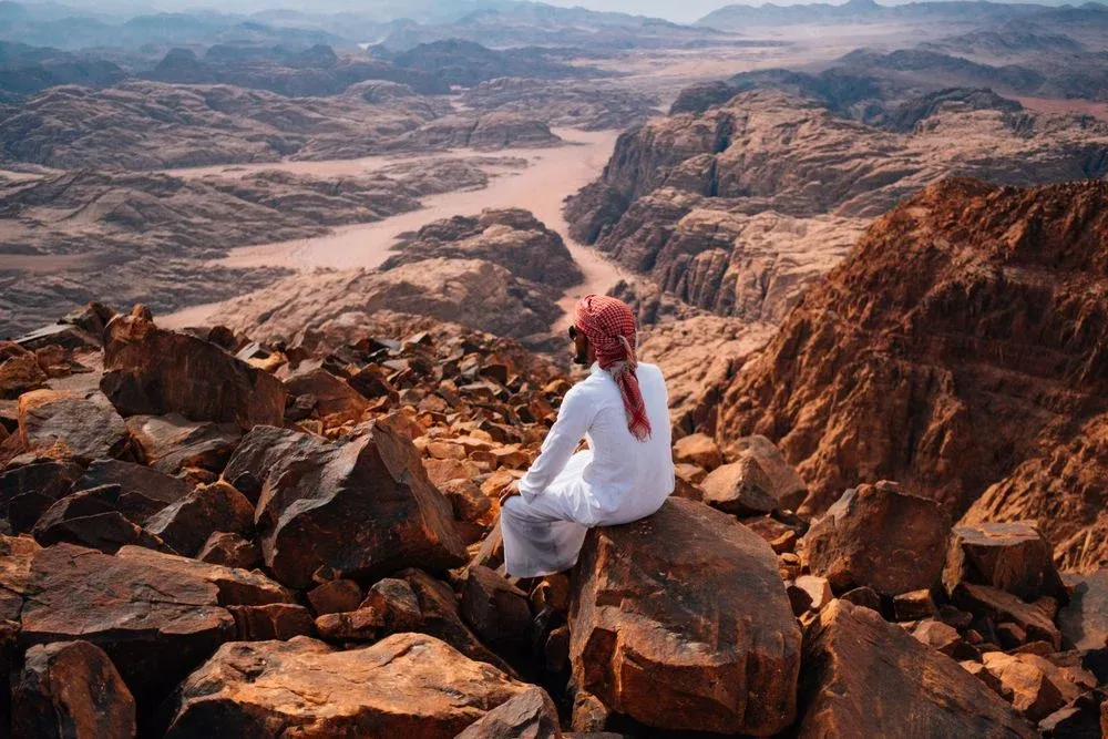 A local guide looks over the rock formations of the The Jordan Trail, which runs through the country. Photo: Tom Barker