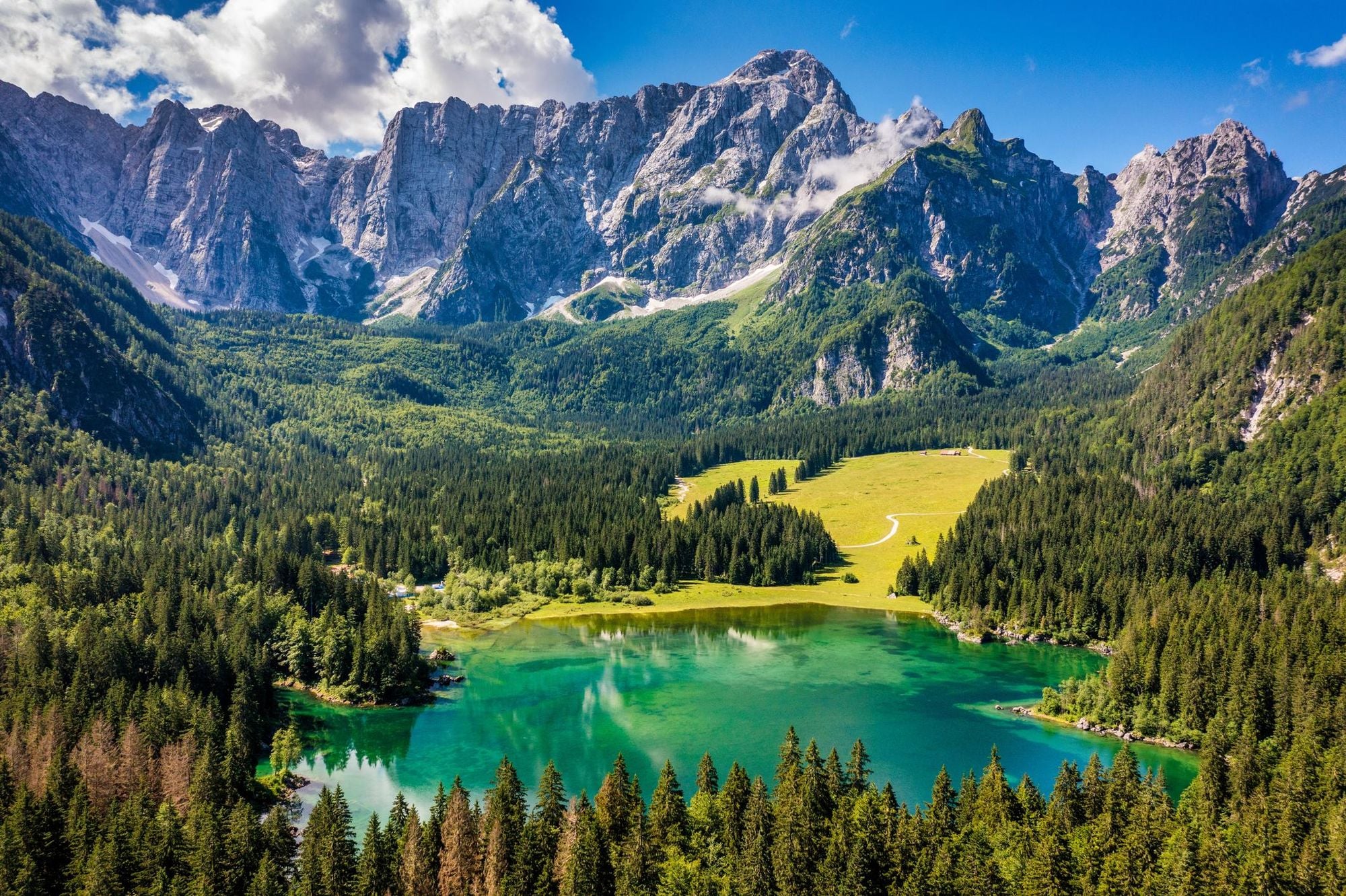 The Lake of Fusine (Lago Superiore di Fusine) and the Mountain Range of Mount Mangart in the Julian Alps. Photo: Getty