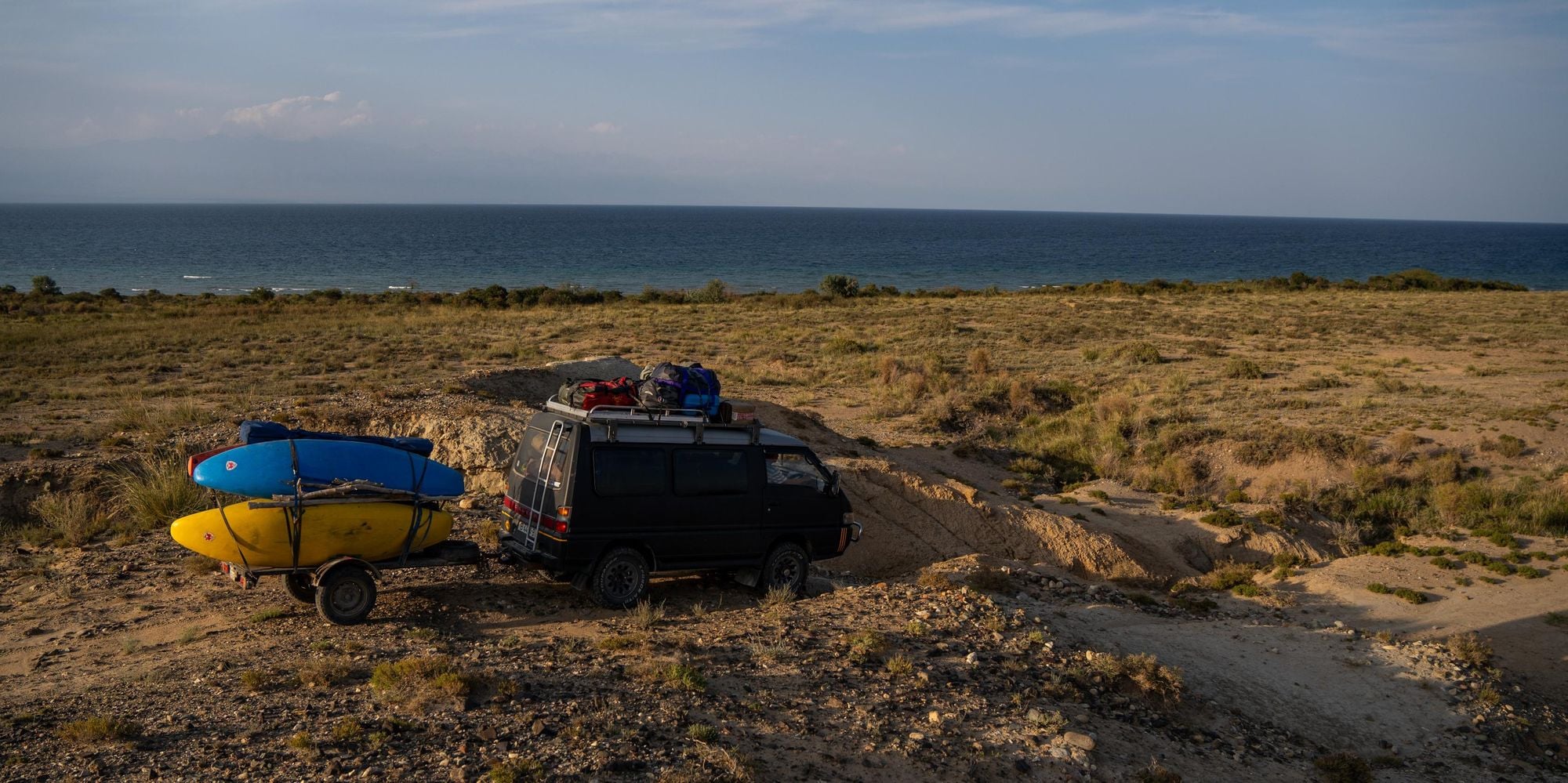 An old vehicle and a tow full of kayaks on the banks of Issyk Kul. Photo: Michal Kuthan