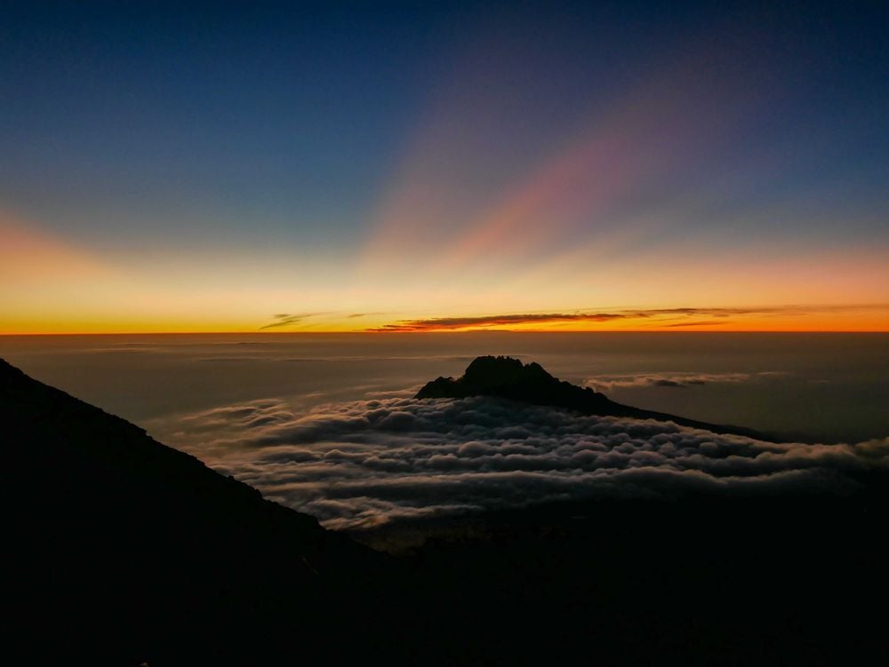 The beginnings of dawn behind Mawenzi Peak, near the highest point in Africa. Photo: Kirsty Holmes