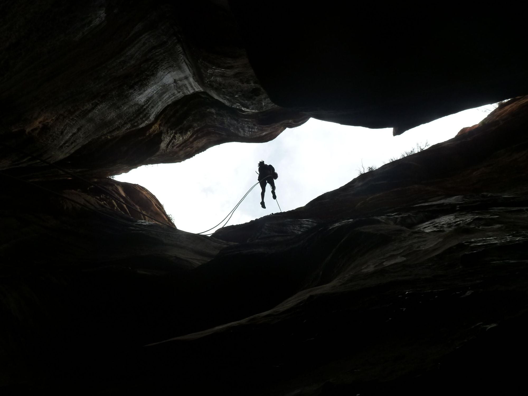 Abseiling into a canyon. Photo: Getty.