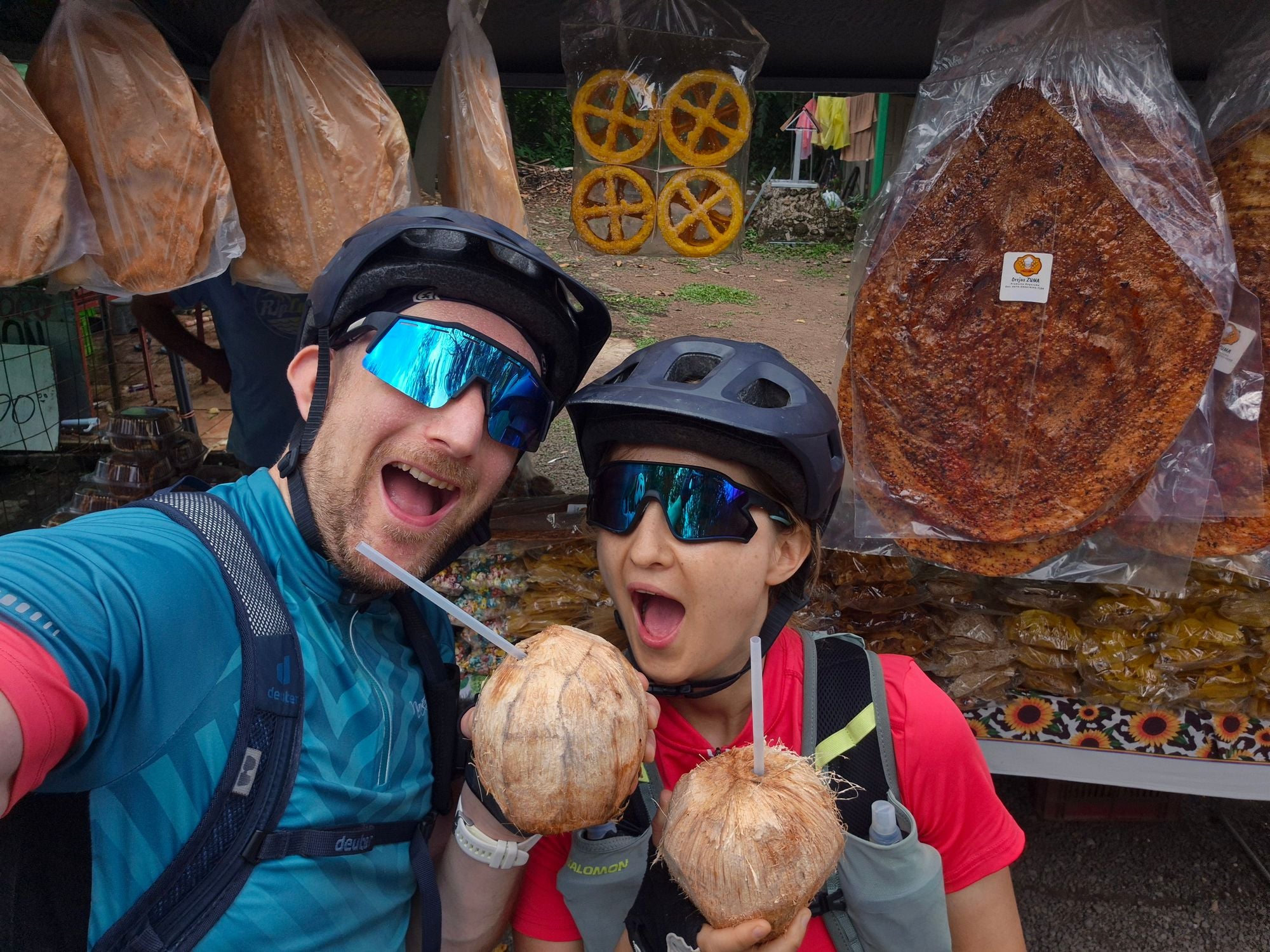 Man and woman drinking from fresh coconuts in Costa Rica.