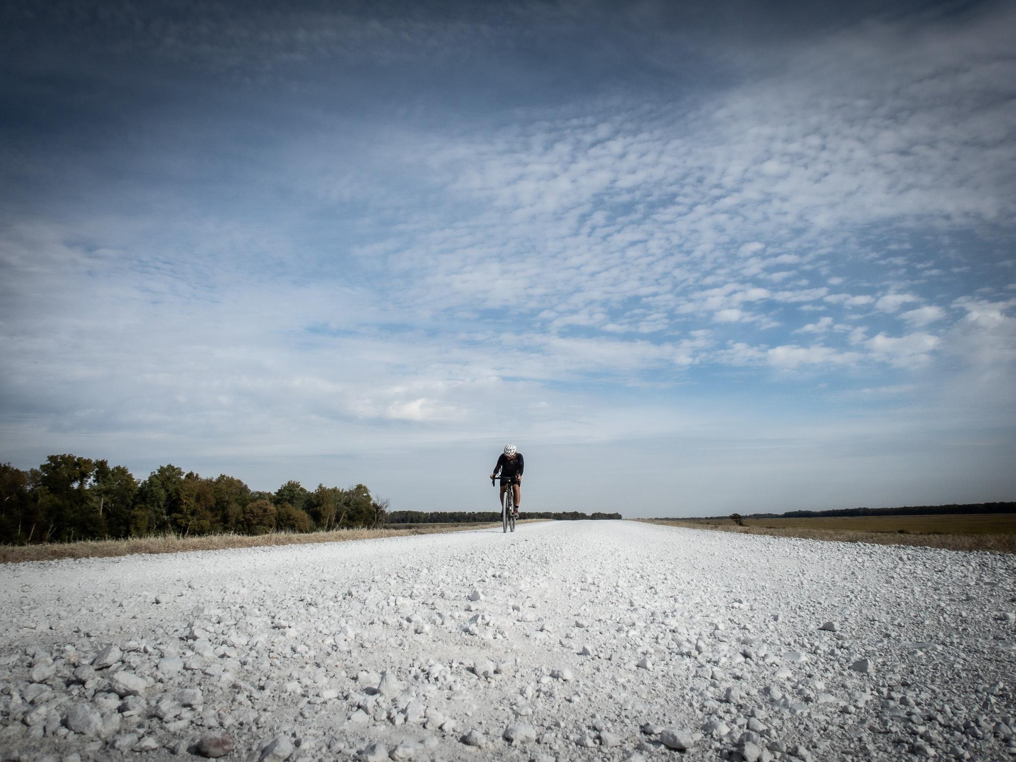 Markus Stitz riding the rocks of Crowley's Ridge Gravel Trail, with only the horizon behind. Photo: Markus Stitz