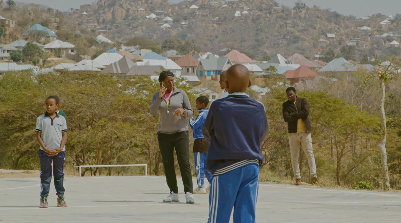 Coach and netball legend Maggie Birkinshaw on the court during a trial in Tanzania. Photo: A Tent with a View