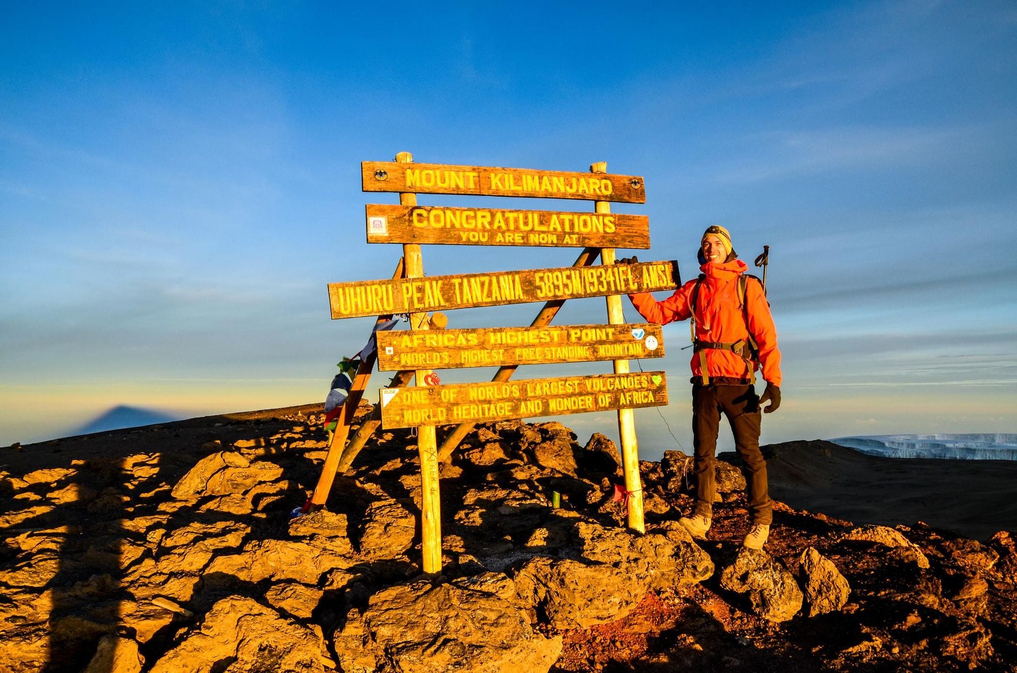 A hiker standing on Uhuru Peak, the summit of Kibo and highest mountain in Africa, Mount Kilimanjaro at 5,895m. Photo: Getty