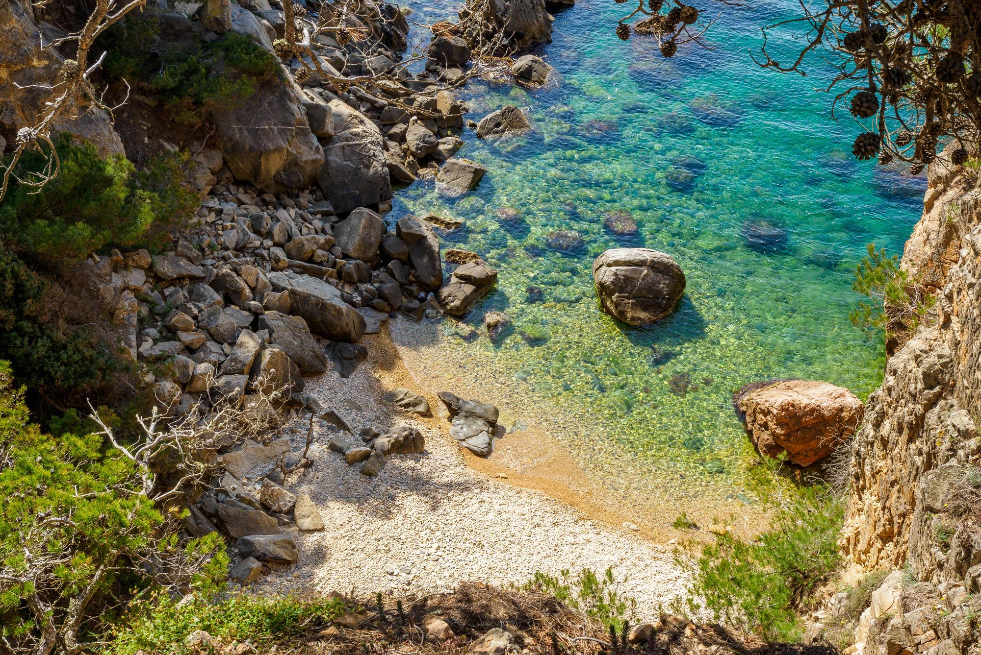 A secluded cove with emerald green water near Palamos, Costa Brava. Photo: Getty