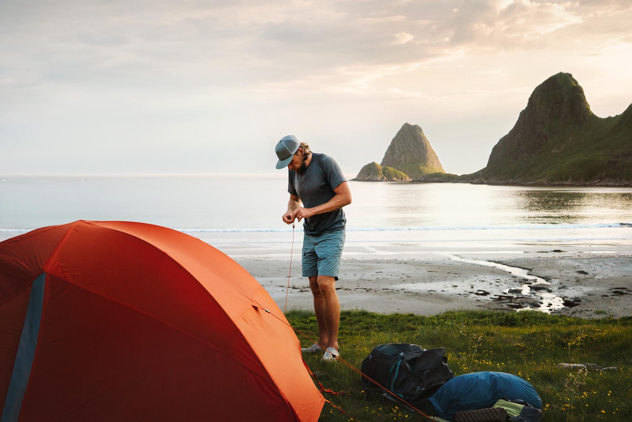 Pitching the tent for the night on the edge of the Lofoten Islands. Photo: Getty
