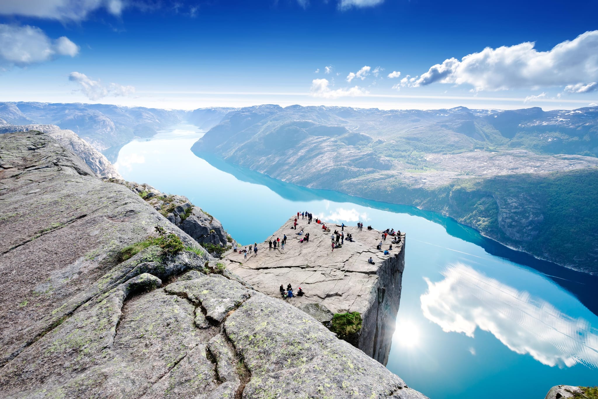 A view from above of Puplit Rock during the day, with a crowd looking out on the fjord. Photo: Shutterstock