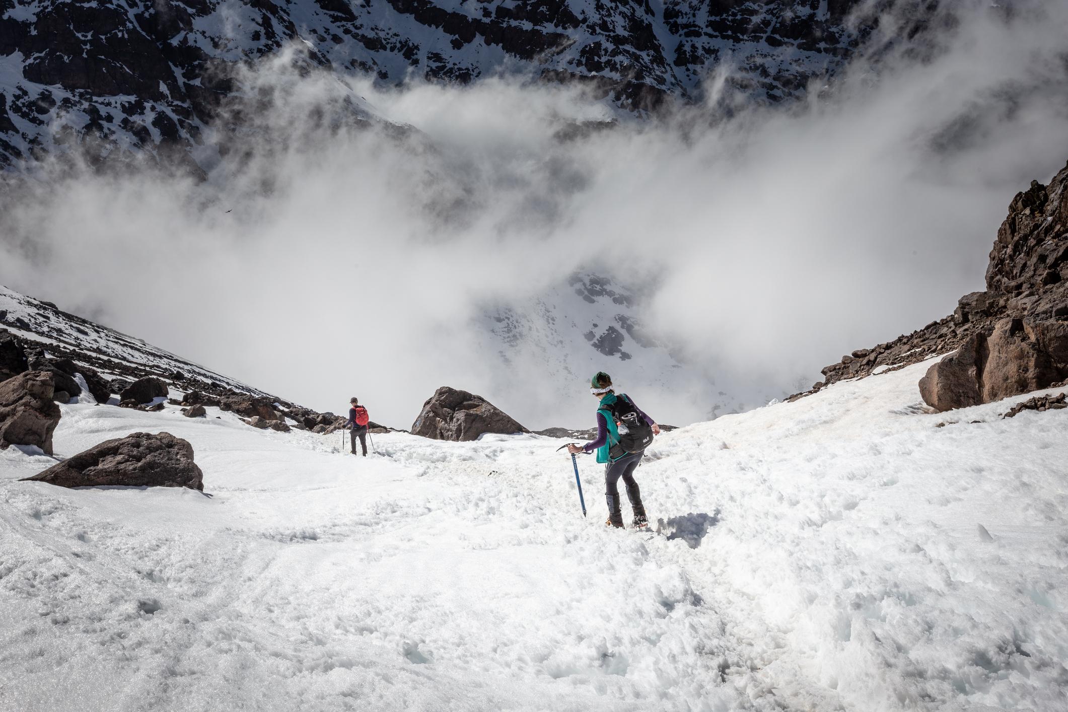 A hiker works their way back down the snow of Toubkal, with an ice axe still in hand. Photo: Getty