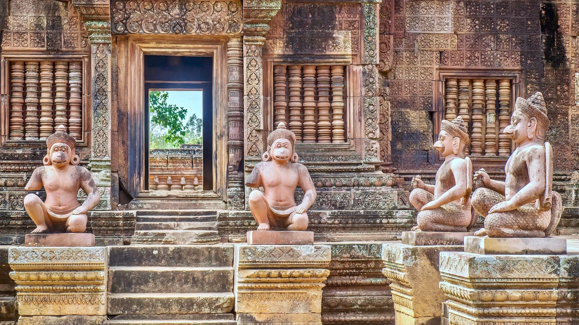 Human figures with animal heads at the entrance to the 10th century Banteay Srei temple at Angkor Wat. Photo: Getty