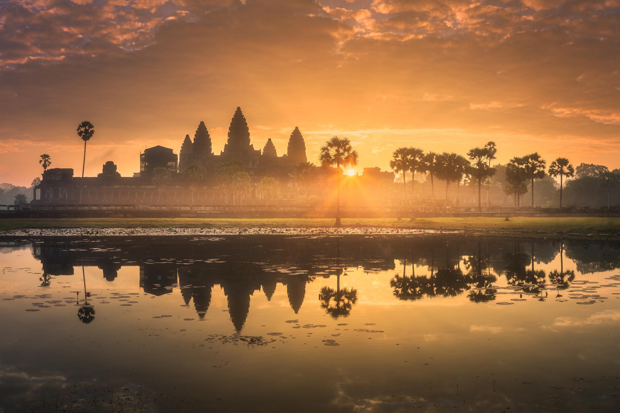 Sunrise over the ancient temple complex of Angkor Wat, with the site reflected in lake Siem Reap. Photo: Getty