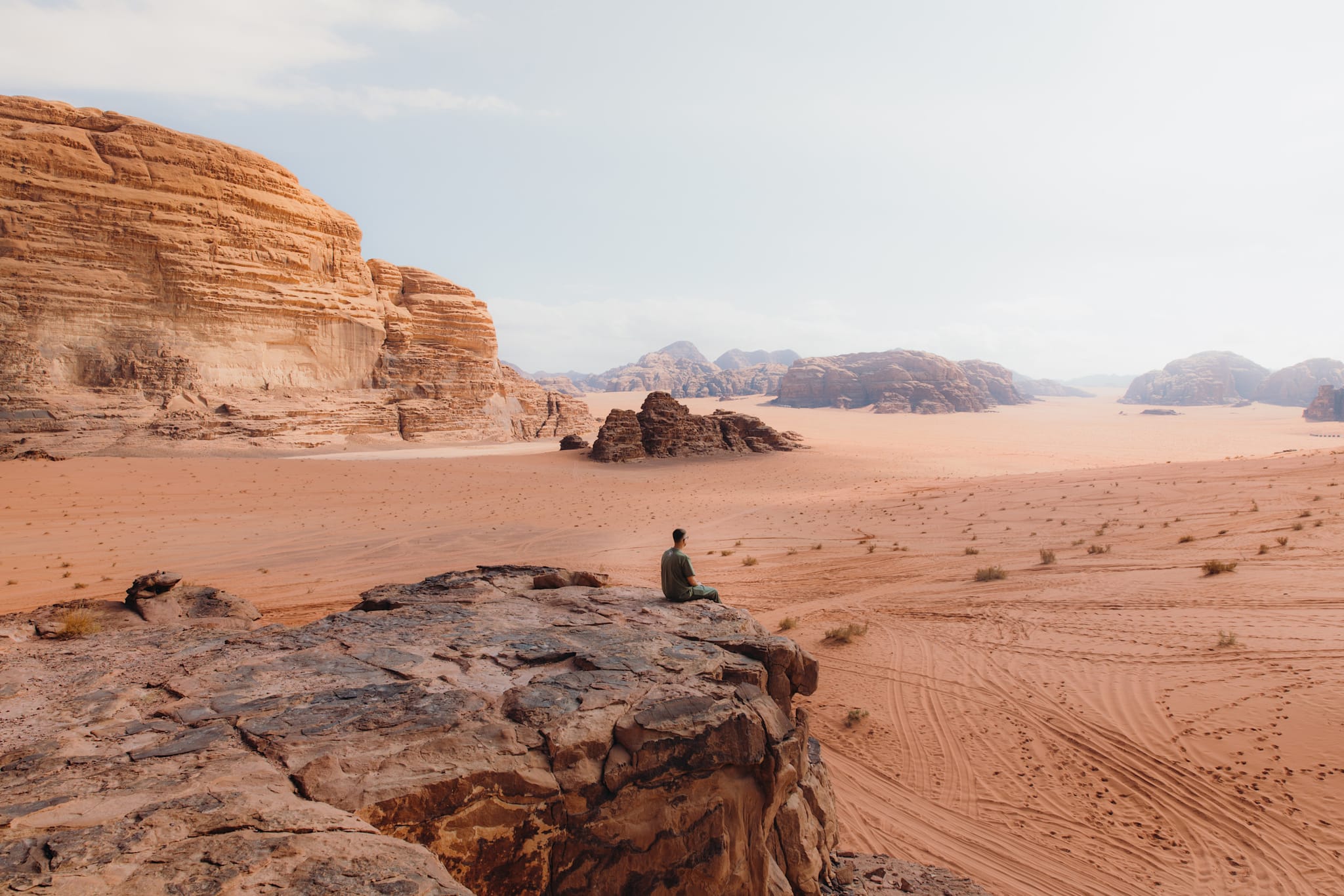 A hiker taking in the serenity of Wadi Rum, where Hollywood films such as The Martian were filmed. Photo: Getty