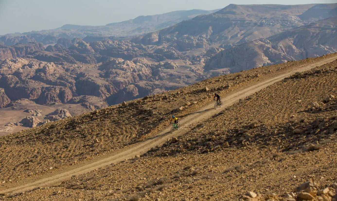 Two cyclists make their way down a track on the Jordan Bike Trail. Photo: Experience Jordan